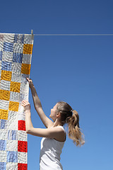 Image showing Young woman and bright laundry