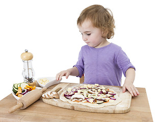 Image showing preschooler making fresh pizza