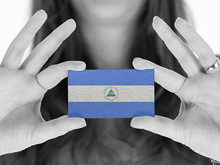 Image showing Woman showing a business card