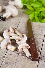 Image showing  fresh sliced champignons with parsley and old knife