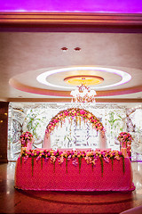 Image showing Floral arch and a table