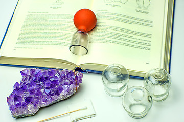 Image showing Cupping glasses with textbook