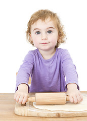 Image showing young child rolling out dough