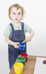 Image showing little girl with brush in paint tub