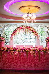 Image showing Floral arch and a table