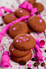 Image showing fresh chocolate cookies, coffee beans, pink ribbons and confetti