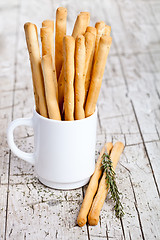 Image showing cup with bread sticks grissini and rosemary