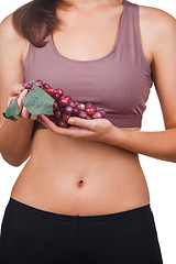 Image showing Beautiful woman holding a bunch of grapes