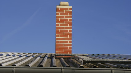 Image showing chimney on a tin roof