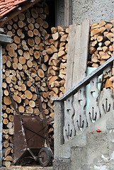 Image showing Stack of Woods and Rusty Cart