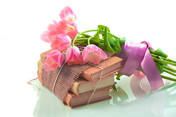 Image showing Pink tulips on old books
