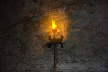 Image showing torch on the wall of an old castle