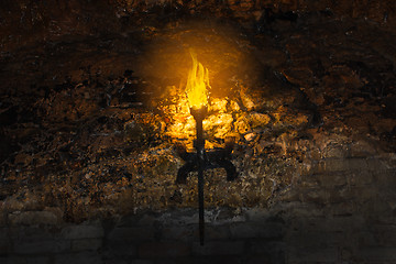 Image showing torch on the wall of an old castle