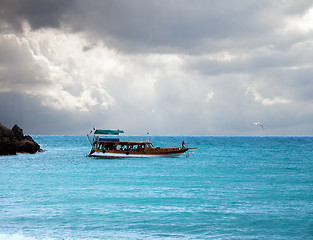 Image showing boat in the sea and stormy sky