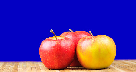 Image showing apple lying on a bamboo napkin