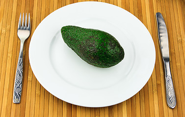 Image showing avocado on a plate with cutlery