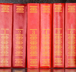 Image showing Red books standing in a row