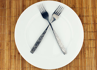 Image showing White plate, fork crosswise