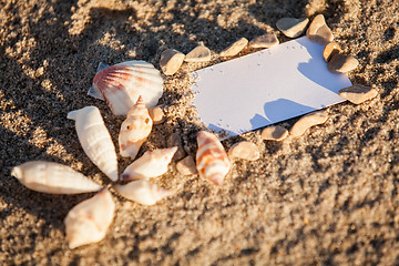 Image showing sailing boat and seashell in sand decoration closeup