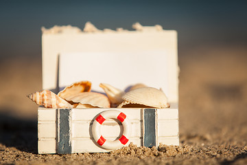 Image showing sailing boat and seashell in sand decoration closeup