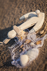 Image showing sailing boat and seashell in sand decoration closeup