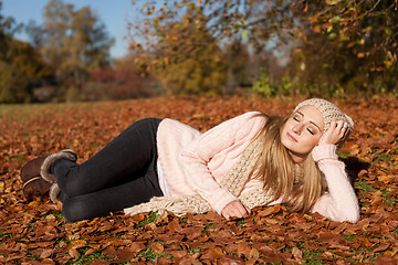 Image showing young smiling woman with hat and scarf outdoor in autumn