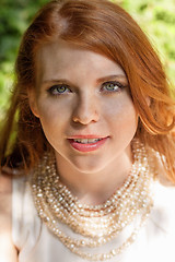 Image showing beautiful smiling young redhead woman portrait outdoor