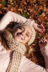 Image showing young smiling woman with hat and scarf outdoor in autumn