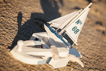 Image showing sailing boat and seashell in sand decoration closeup