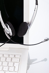 Image showing headset keyboard notebook laptop in office on table desk