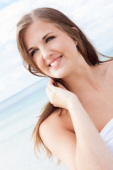 Image showing smiling young brunette woman in summer on the beach 