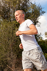 Image showing athletic man runner jogging in nature outdoor