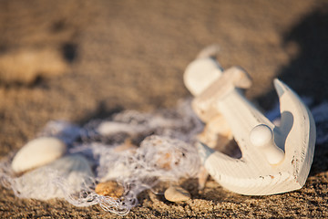 Image showing sailing boat and seashell in sand decoration closeup