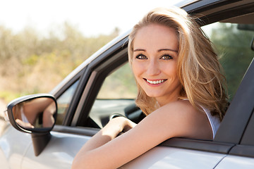 Image showing young attractive happy woman sitting in car summertime