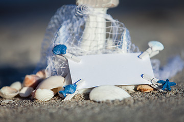 Image showing sailing boat and seashell in sand decoration closeup