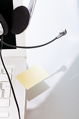 Image showing headset keyboard notebook laptop in office on table desk