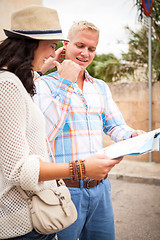 Image showing young attractive tourist couple with city map in summer