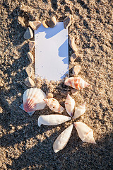 Image showing sailing boat and seashell in sand decoration closeup