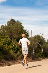 Image showing athletic man runner jogging in nature outdoor