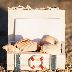 Image showing sailing boat and seashell in sand decoration closeup