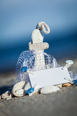 Image showing sailing boat and seashell in sand decoration closeup