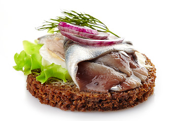 Image showing brown bread canape with anchovies decorated with red onion and d