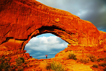 Image showing Woman staying with raised hands inside an Arch