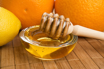 Image showing fresh honey with lemon and orange fruits