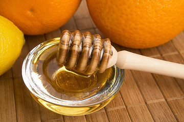 Image showing fresh honey with lemon and orange fruits
