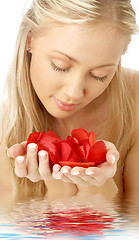 Image showing lovely blond in water with red rose petals