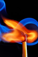 Image showing lighting a match on black background