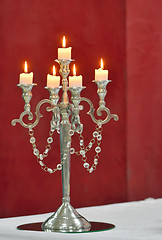 Image showing Silver classic candlestick isolated on red