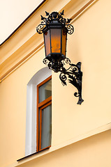 Image showing Old lamp with windows on wall