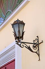 Image showing Old lamp with stained glass window on wall